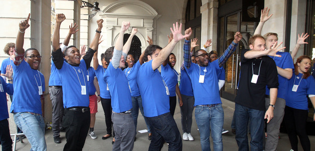Apple staff giving the customers a welcome outside the Apple Store in Covent Garden