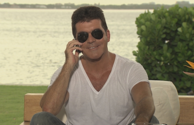 Simon Cowell telling the judges their categories on The X Factor.