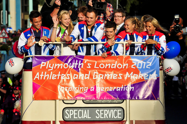 Plymouth based Olympic and Paralympic athletes, including Tom Daley (left) aboard an open top bus as they process through the streets of Plymouth, where thousands of people have turned out to welcome them home from the games (19/09/2012)