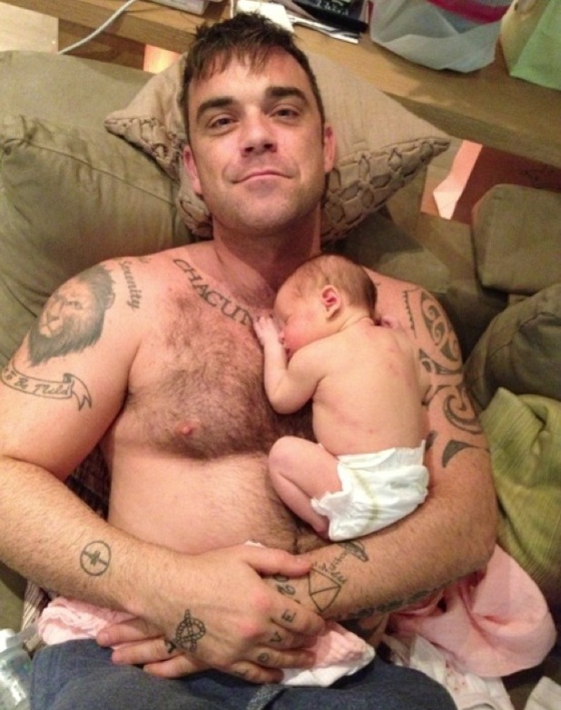 Robbie Williams holds daughter Theodora Rose
