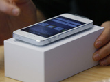 A customer tests the new iPhone 5 at the Apple store in Hong Kong