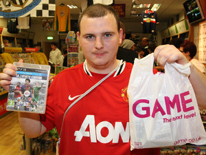 Martin Keenan from Gateshead is the first to buy a copy of FIFA 13 at GAME's Gateshead Metro Centre store in Newcastle Upon Tyne