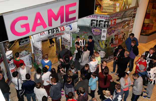 People are seen waiting topurchae the first copy of FIFA 13 at GAME's Gateshead Metro Centre store in Newcastle Upon Tyne