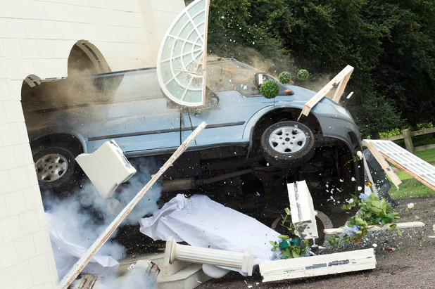 The Minibus crashes through the Orangery.