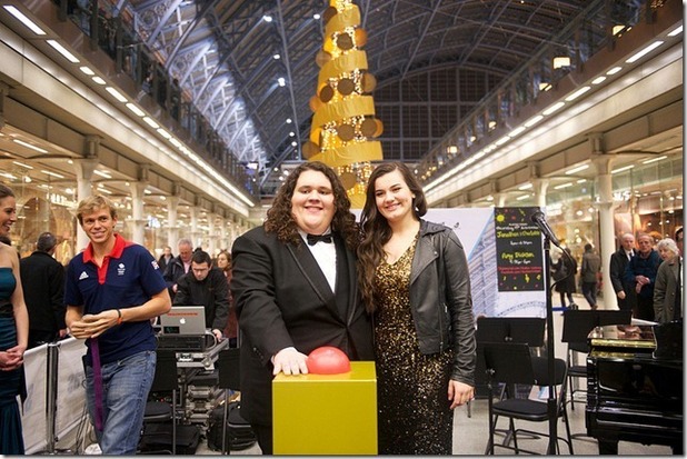 Jonathan & Charlotte turn on the Christmas tree light in St. Pancras International, London.