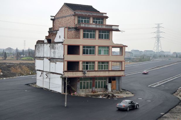 House in the middle of road