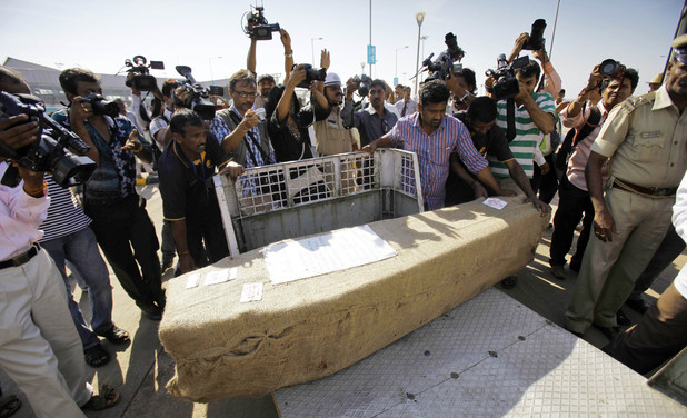 Indian journalists take pictures of a casket containing the body of Jacintha Saldanha following its arrival in Mangalore, India