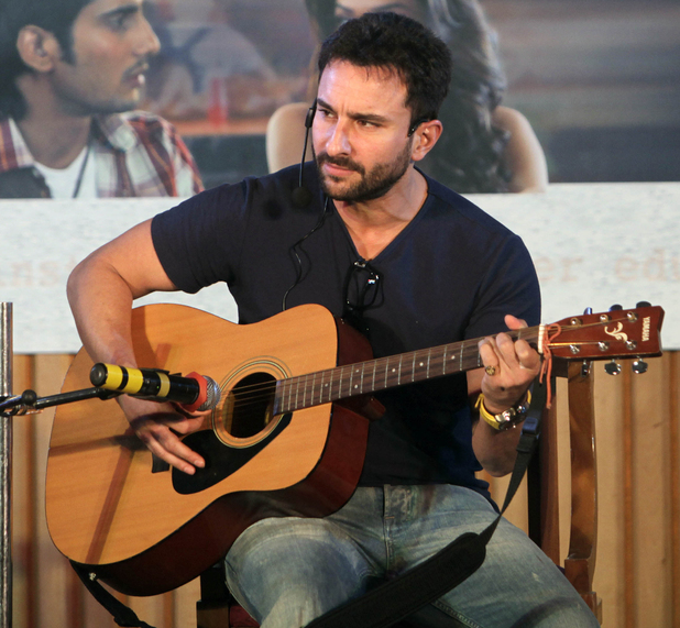 Bollywood actor Saif Ali Khan plays guitar during a promotion of his film "Aarakshan" in Mumbai, India, Tuesday, Aug. 2, 2011.