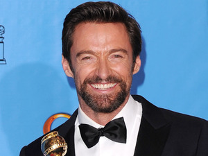 Hugh Jackman poses with the award for for actor (musical or comedy) for "Les Misérables" backstage at the 70th Annual Golden Globe Awards
