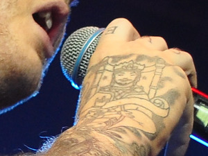James Arthur,showing off his new tattoo of a musician sitting on a throne
