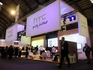 Participants gather around the HTC stand at the Mobile World Congress in Barcelona, Spain, Thursday, Feb. 17, 2011. The Mobile World Congress is held from Feb. 14-17