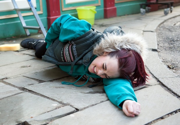 Sinead falls and lands on the pavement.