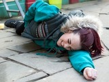 Sinead falls and lands on the pavement.
