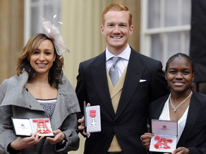 Jessica Ennis, Greg Rutherford and Nicola Adams with guards at Buckingham Palace