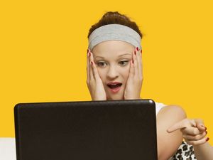 woman on computer shocked
