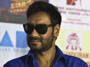 Ajay Devgan and Abhishek Bachchan arrive for a promotional event for their new film 'Bol Bachchan' in New Delhi, India, Wednesday, July 4, 2012. The romantic comedy is scheduled to be released on July 6. 