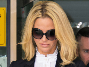 Girls Aloud star Sarah Harding leaves court after being banned from driving for six months.