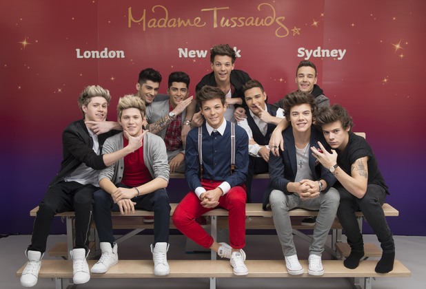 One Direction pose with wax figures at Madame Tussauds