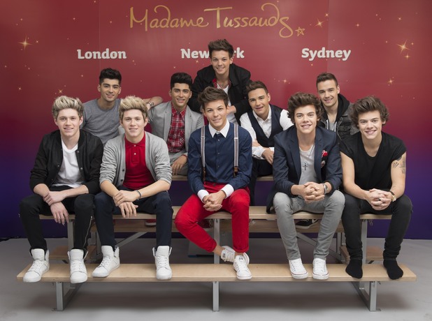 One Direction pose with wax figures at Madame Tussauds