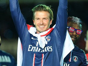 David Beckham celebrates with the French Ligue One Trophy.
