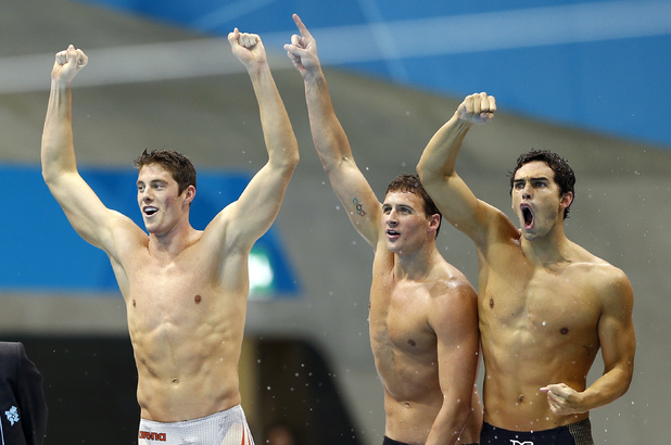 Ryan Lochte, Conor Dwyer, left, Ryan Lochte, center, and Ricky Berens, right, celebrate as Michael Phelps closes in on their team's gold medal win in the men's 4 x 200-meter freestyle relay at the Aquatics Centre in the Olympic Park during the 2012 Summer Olympics
