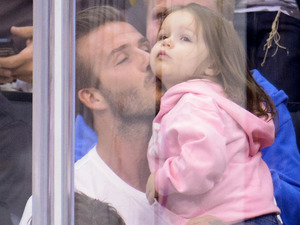 David Beckham kisses his daughter Harper at an NHL playoff game between the San Jose Sharks and the Los Angeles King