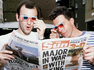 Men look at page 3 in 'The Sun' using 3D glasses