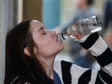 Lauren drinks in an alleyway