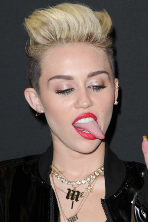 Miley Cyrus and her trademark tongue pose through the years.