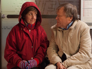 Roy and Hayley sit outside in the snow.