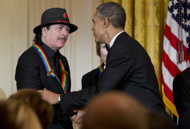 President Obama congratulates Carlos Santana at the Kennedy Center Honors in the East Room of the White House