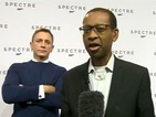 Daniel Craig photobombs the BBC's Lizo Mzimba in live report